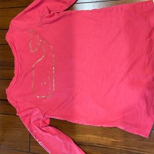 Pink long sleeve shirt with gold logo on the front and back with purple letters